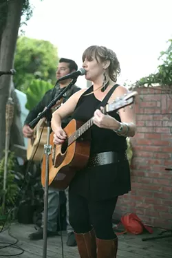 SING IT, SISTER! : Natalie Haskins put her high lonesome voice through a workout last Friday at ECO Show, a sustainable fashion show at Creeky Tiki. - PHOTO BY GLEN STARKEY