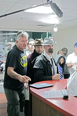 THE DIRECTOR: Adventure Club SLO leader John “Johnee” Gange (left) works with his cast at No Slack Studios on their new film "Revenge of Blue Harbor," premiering Dec. 6 at the Palm Theatre. - PHOTO BY GLEN STARKEY