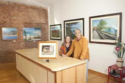 HOME AGAIN : John Ramos—pictured here in his new gallery with his wife, Donna—returned to the area after living for four years in Mexico. - PHOTO BY STEVE E. MILLER