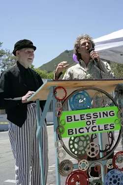 HOLY ROLLERS!: Robert Norton (left) took care of the bike blessing, and Mark “Gizmo” Grayson acted as Master of Ceremonies at the inaugural SLO Blessing of the Bicycles on May 18 at Salon 544, at 544 Higuera St. - PHOTO BY GLEN STARKEY