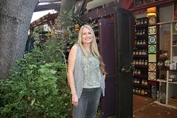 THE ALCHEMIST: The Secret Garden Owner Kirstin Sherritt sells remarkable all-natural teas, herbs, and spices out of her open-air shop near SLO Creek. - PHOTO BY HAYLEY THOMAS