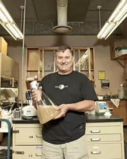 THE PITCH : Using 45-million-year-old yeast harvested from fossilized amber, Dr. Raul Cano, a Cal Poly microbiologist, brews beer. He’s used the same samples collected in 1996 to create the “pitch” used as a base in the brewing process. - PHOTO BY STEVE E. MILLER