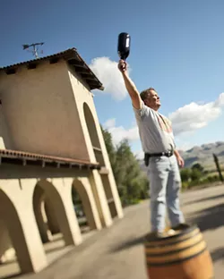 ONE FOR ALL : Vintner Mike Sinor stands triumphant at the old Corbett Canyon Winery. - PHOTO BY STEVE E. MILLER