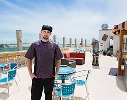 THE ROOF IS ON FIRE : Gaviota Grill Head Chef Jesse Morrow shows off the new restaurant’s crown jewel: a rooftop patio seating area complete with heaters, funky maritime décor, and an unobstructed seaside sunset view. - PHOTO BY KAORI FUNAHASHI