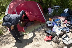 ANYBODY HOME? :  SLO Police Officer Kevin Waddell checks in on two illegal campers near San Luis Obispo Creek while on a CAT (Community Action Team) shift.