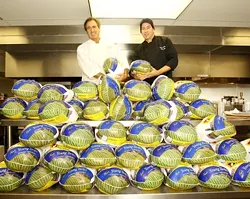 BIRD IS THE WORD : Jose Dahan (left) and sous chef Jason Chenaux (right) of Et Voila were already preparing for Thanksgiving on Nov. 13 when a load of turkeys arrived at the restaurant. - PHOTO BY STEVE E. MILLER