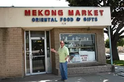 CHEF RICK'S FINE FIND : Enthusaistic Chef Rick Manson outside the Mekong Market, which offers rare and interesting ingredients like frozen pig's blood, canned mud carp and ground dried fish by the pound . - PHOTO BY DAN HARDESTY