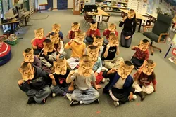 LEARNING ABOUT LIONS : Kindergarten students in Suzanne Nichols’ class at Hawthorne School enjoy acting like mountain lions as part of their studies. - PHOTO BY CHRISTOPHER GARDNER