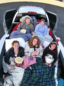 BEANBAGS IN PARADISE: Eric and Becca Norrbom (in the back) brought nieces (left to right) Jessica and Christina Leahy and their friend Hannah Villegas to the drive-in, loading beanbag chairs in the back of a pickup. - CHRISTOPHER GARDNER