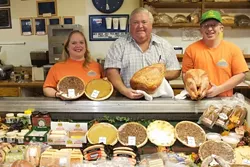 ALL IN THE FAMILY : Old Country Deli owner Norm Eggen (center) runs the business with his kids Elizabeth and William. They have a reputation for making some of the best smoked turkeys and hams in town.