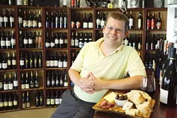 WINE AND COFFEE : Avila Wine & Roasting Co. manager Brandon Edmonds loves wine, and his passion and experience shine through at the shop. - PHOTO BY STEVE E. MILLER