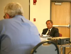 ED AND EDUCATION : A straight-faced Ed Maduli listened while a local resident called for his resignation in light of Measure G’s failure. The Board of Trustees has held numerous closed-session meetings over the past two weeks to conduct an annual evaluation of the Cuesta College vice president—and President Marie Rosenwasser—all of which led to speculation of a looming change in the college’s administration. - PHOTO BY JESSE ACOSTA