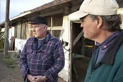 RAIDED : Henri DeGroot (left), owner of the 40-acre former chicken farm that was searched last month, and John Brigham (right), who operates a recycled furniture woodshop on the property, claim that there was something fishy about a recent raid. - PHOTO BY STEVE E MILLER