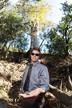 ARBOREAL : Ecologist Matt Ritter of Cal Poly studies the germination of eucalyptus - species. He compiled a short list of genus members with the proven ability to reproduce in California. The mammoth Karri eucalyptus specimen behind him is not one. - PHOTO BY JESSE ACOSTA