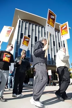 SIGNS OF THE TIMES : Faculty members picketed the administration building at Cal Poly on Jan. 16. The event was part of a statewide move by the California State University Faculty Union throughout January to raise awareness of a bargaining impasse in contract negotiations with CSU administrators. - PHOTO BY JESSE ACOSTA