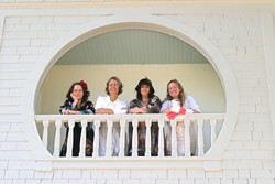 FOUR FLEW OVER THE CUCKOOS NEST Heidi Harmon, Suzi Kyle, Sonya Lea, and Tracy Taylor (left to right) survey the property and beckon guests from one of the historic houses many verandas. - CHRISTOPHER GARDNER