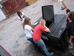 IN THE LINE OF DUTY : (l-r) Audrey Faber, Alyssa Tennant, Aubrey Wynn, and Caitlyn Arigo checked the quality of the vegetable oil at a storage bin in Gallup, N.M., to ensure that there's no shortening. - PHOTO COURTESY OF VEGGIE GIRLS
