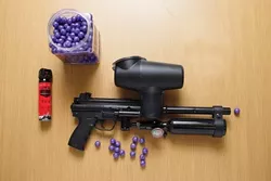RED-EYE FIGHT : Paintballs filled with pore-stinging Oleoresin Capsicum provide officers with an option besides batons or guns. - PHOTO BY STEVE E. MILLER