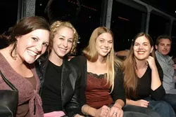 PARTY GIRLS (LEFT TO RIGHT): Kerry Moore (sales), Lorna Kreutz (Kerry’s rommmate), Dora Mountain (production), and Kirsten Blake (sales) get comfy on The Galaxy, the rolling disco party bus from Stardust Limo. - CHRISTOPHER GARDNER
