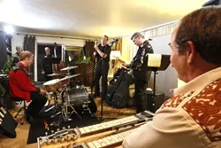 PRACTICE MAKES PERFECT : The Bangin' 58's work through some songs in singer Paul Brown's living room. - PHOTO BY STEVE E. MILLER