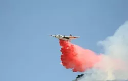 BOMBS AWAY : A CDF bomber dropped a payload of fire retardant - compound on a field of wildfire fuel on June 23. - PHOTO BY JESSE ACOSTA