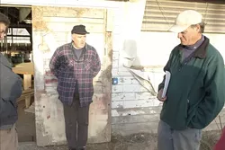 MOVING FORWARD : John Brigham's (right) furniture business is one of two operations allowed to maintain shop in former chicken coops on Nipomo land owned by Henri DeGroot (left). The property has been the site of clashes with fire and code enforcement officials, and the bulk of the tenants are being told to leave by May 1. - PHOTO BY STEVE E. MILLER