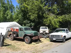 VALUABLE VEHICLES? : Ken Slusser collects and restores military vehicles, which he keeps in his Santa Margarita yard. SLO County code enforcement officials are issuing clean-up orders and fines for vehicles stored outdoors in the Santa Margarita area, and are telling Slusser to pay up. - PHOTO BY KATHY JOHNSTON