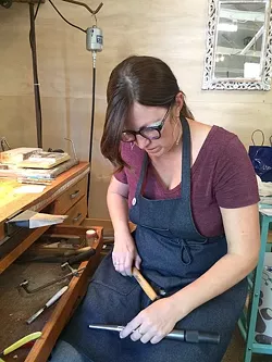 SOLDERING AWAY: Jeweler Kerry Long cuts, solders, and hammers away at her workspace at The Bunker in SLO as she creates one-of-a-kind metal jewelry. - PHOTO COURTESY OF KERRY LONG
