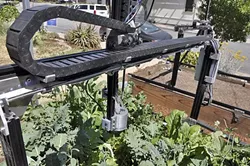 WATERBOT : FarmBot irrigates individual plants in a raised garden bed. Version 10 will be available for pre-order starting on July 10 at farmbot.io. - PHOTO BY CAMILLIA LANHAM