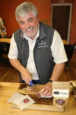 PORK PLATE: Chef/Owner of Buona Tavola restaurants and Alle-Pia Fine Cured Meats Antonio Varia spices up fragrant, earthy truffle salumi cured at his Atascadero Emporio and processing facility. - PHOTO BY DYLAN HONEA-BAUMANN