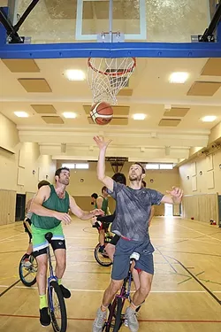 GOING FOR THE GOLD: Mark Wilder (left) and his SLO Ballerz teammates prepare to compete in unicycle basketball at Unicon, the Olympics for all things unicycle, this August in San Sebastian, Spain. The team took the bronze medal at the games in Montreal, Canada, in 2014. - PHOTO BY DYLAN HONEA-BAUMANN