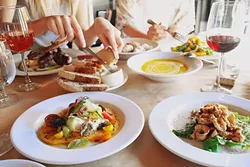COME TOGETHER: Kendra Aronson loves photographing big table spreads where friends are sharing good food, like this photo from a meal at Ember in Grover Beach. - IMAGE COURTESY OF KENDRA ARONSON