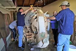 BUILDING A RHINOCEROS: Local artists Abby Belknap, Creig C. Sherburne, Lucie Ryan, and Larry Le Brane work on building a life-sized rhinoceros. - PHOTO BY DYLAN HONEA-BAUMANN