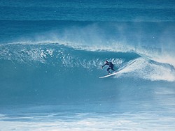 TOP TO BOTTOM:  Cass Holuk surfs at his favorite spot, Jeffreys Bay in South Africa, 1990. - PHOTO COURTESY OF CASS HOLUK
