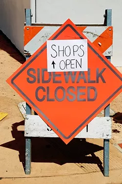 CLOPING: The shuttered parking lot, closed sidewalks, and construction activity has made things difficult for some of the locally-owned businesses surrounding the Chinatown project on Monterey Street in downtown SLO. - PHOTO BY DYLAN HONEA-BAUMANN