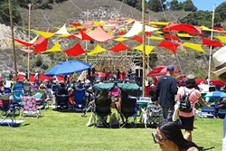 A PERFECT DAY: Dead Feather Moon, an alternative rock band from San Diego, revs up the crowd from the custom bamboo stage on a clear, blue-sky day. - PHOTO BY GLEN STARKEY