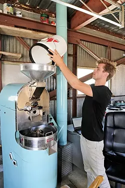 A NEW PARADIGM: Paradigm Coffee co-founder and Roastmaster Reid Patterson roasts site-specific beans from Costa Rica with a state-of-the-art roaster he purchased from friend and fellow specialty coffee nerd Jonathan Strauf, owner of downtown coffee hub Bello Mundo. - PHOTO BY DYLAN HONNEA-BAUMANN
