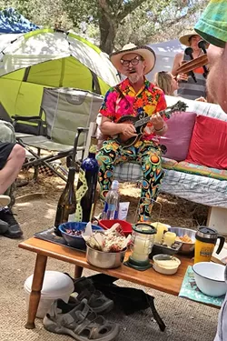 CRAVEN IN THE HOUSE: Festival emcee Joe Craven made an impromptu visit to our camp’s Mad Hatter tea party and laid down some jams. - PHOTO BY GLEN STARKEY