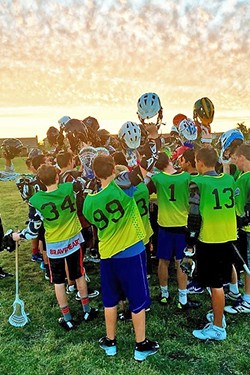 GAME OVER:  805 Lax players huddle up after a game. Spring season starts in March and the club is hosting a free lacrosse clinic on Jan. 28 at Bishop Peak Elementary School in SLO. - PHOTO COURTESY OF 805 LAX