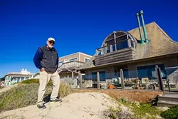 RESIDENT ACTIVIST: Larry Bross, whose backyard is the Oceano Dunes state park, doesn’t want people driving on the strip of beach that runs behind his neighborhood in Oceano. - PHOTO BY JAYSON MELLOM