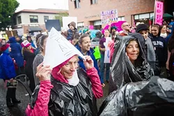 BAD WEATHER, GOOD VIBES: Thousands of men, women, and children braved the rain to turn out at the SLO Women’s March Jan. 21, joining an estimated 4.9 million others participating in similar marches in the U.S. and around the world. - PHOTO BY JAYSON MELLOM