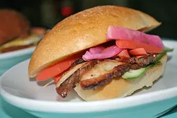 SPICE IS NICE: Café Fiero’s bahn mi has serious spicy staying power. Made with braised pork belly, cucumber, mint, cilantro, house pickled carrots, daikon, serrano peppers, and sriracha mayo on a pan d’oro Cubano roll, this feast sets you back just $8. - PHOTO BY HAYLEY THOMAS CAIN