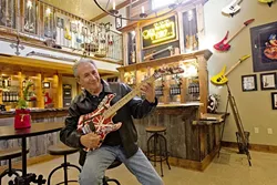 SIPS AND RIFFS: Gary Kramer sits at his wine tasting room in Paso Robles where rare guitars owned by rock ’n’ roll legends like Gene Simmons and Eddie Van Halen hang. - PHOTO BY JAYSON MELLOM