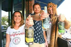 COCKTAIL CREW : From left, Calivore Spirit Co. owners Raleigh Nejame, Aaron Bergh, and Luke Beaton show off their bottles of blonde rum, spiced rum, and Big Sur-inspired gin. - PHOTO BY HAYLEY THOMAS
