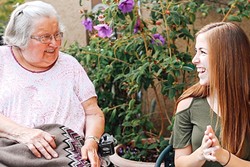 SPECIAL FRIENDSHIP:  Cal Poly student Jaymi Boynton (right) exchanges a laugh with Lorraine Bailey (left), a client with Wilshire Health and Community Services. The two met through the Caring Callers Program, which connects volunteers with homebound seniors seeking companionship. - PHOTO COURTESY OF KELLY DONOHUE