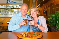 POWER COUPLE : Jeff and Laura Ambrose built a Woostock’s Pizza empire that’s flourished in California college towns for 30-plus years (without the help of kale or any other trendy topping). - PHOTO COURTESY OF WOODSTOCKS PIZZA