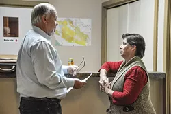 RESIDENT?: The SLO County District Attorney’s Office has filed several felony voter fraud charges against Cal Valley CSD Board President Lisa Marrone, pictured here discussing things with her lawyer Barry Kinman before the Oct. 4 board meeting. - PHOTO BY CAMILLIA LANHAM