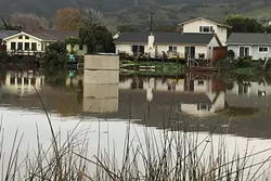 FLOAT ON: A plastic garden shed washed out of a yard abutting Laguna Lake is spotted floating aimlessly along on Jan. 9. - PHOTO BY GLEN STARKEY
