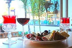 WHAT’S COOKING?: Puffer’s of Pismo wine bar is always serving up gourmet-meets-everyday munchies, like this bountiful plate of cheeses, olives, and more. As a former Chicagoan, bar owner Charlie Puffer is always one to add a bunch of sausages to the mix, too. - PHOTO BY HAYLEY THOMAS CAIN