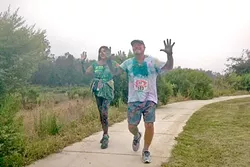 FUN RUN: Runners like these smiled as they were dowsed in colorful powder at Orcutt Community Park Aug. 6. - PHOTO BY CHRIS MCGUINNESS